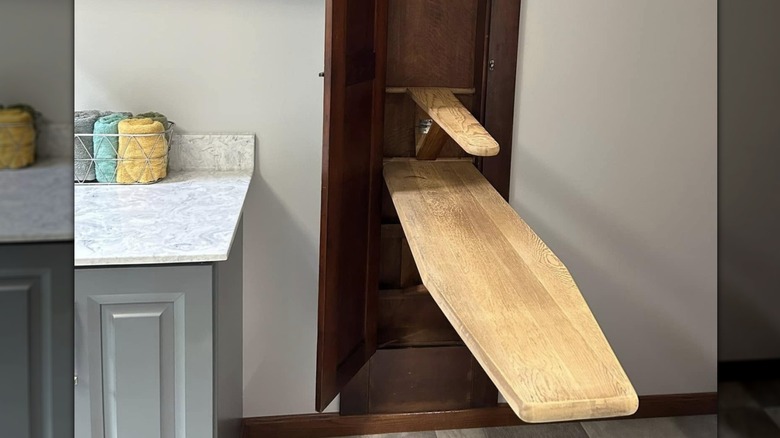 Image of a vintage wooden pull-down ironing board