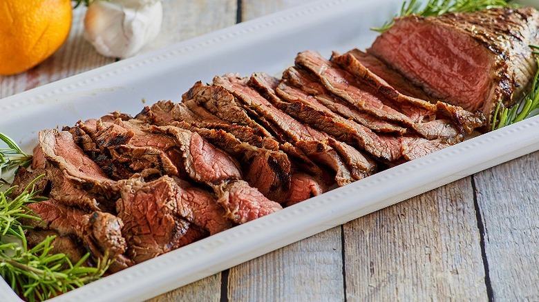 A dish with sliced steak served medium rare