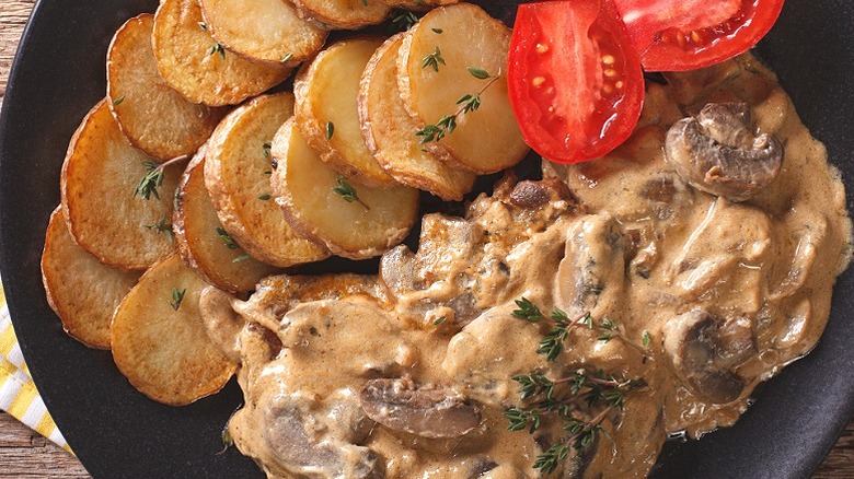 Steak Diane served with potato and tomatoes