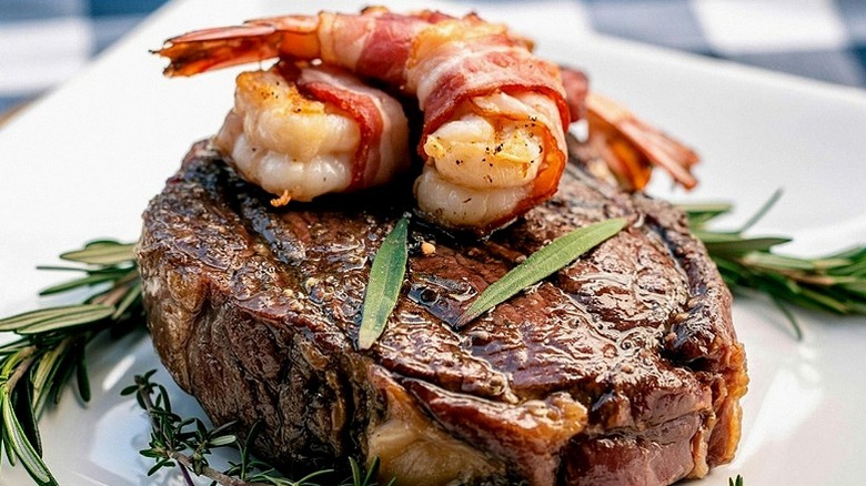 Juicy steak served with two prawns and garnish