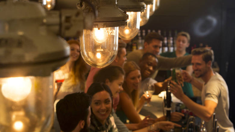 A group of people order drinks at a bar