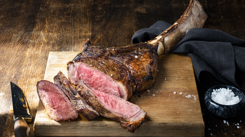 Fogo de Chão tomahawk steak on wood board