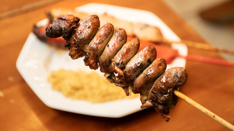 A skewer of chicken hearts