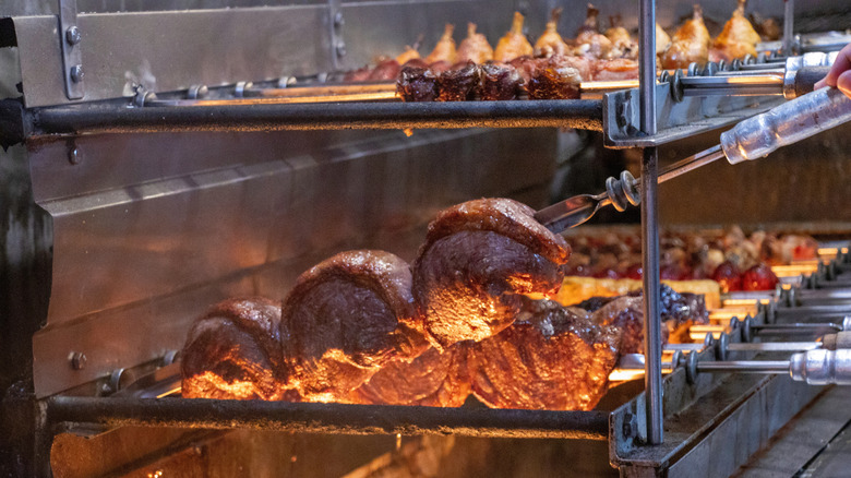 Various meat skewers are cooked in a Brazilian steakhouse