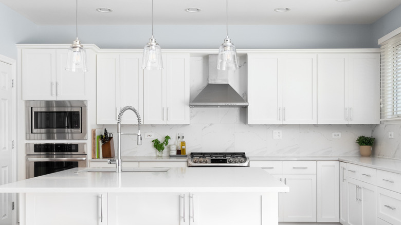 White kitchen cabinets with empty space above