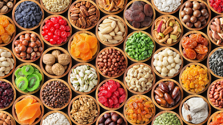 Varrious types of candied fruits, nuts, and dried fruits in wooden bowls