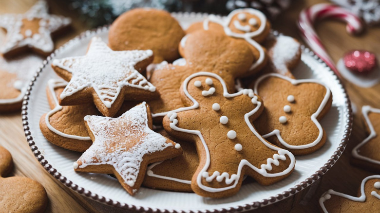 Gingerbread cookies on a white plate placed on a wooden table