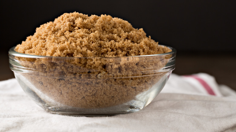 Close up of a glass bowl full of light brown sugar