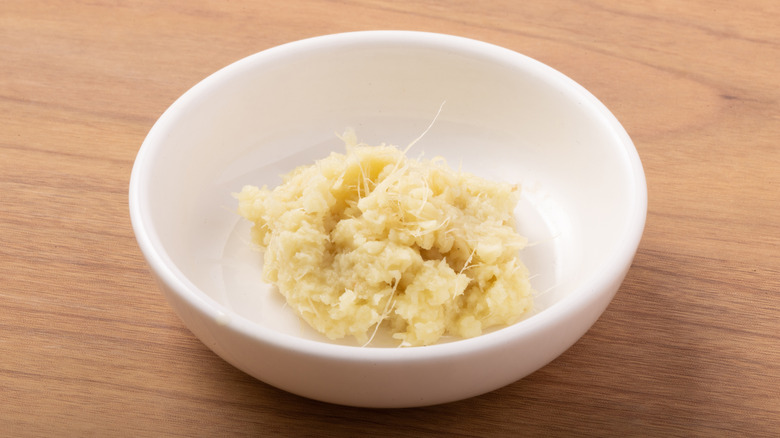 A small white bowl of grated ginger