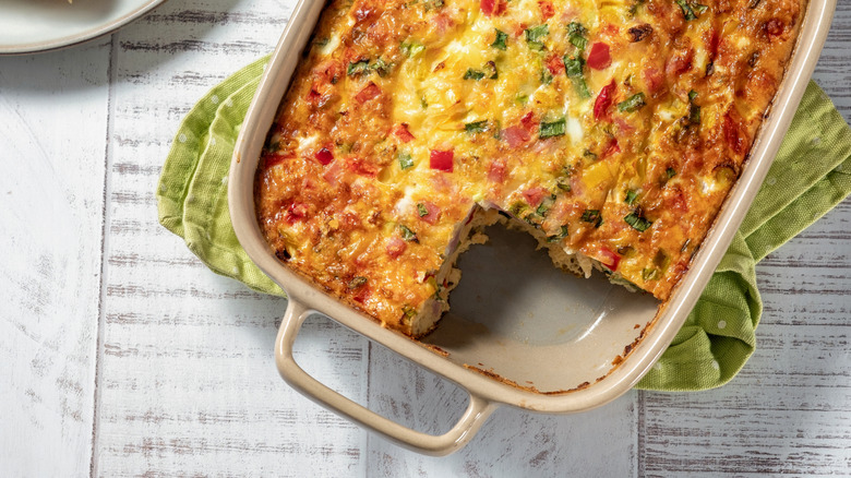 Close up of a breakfast casserole with a piece cut out