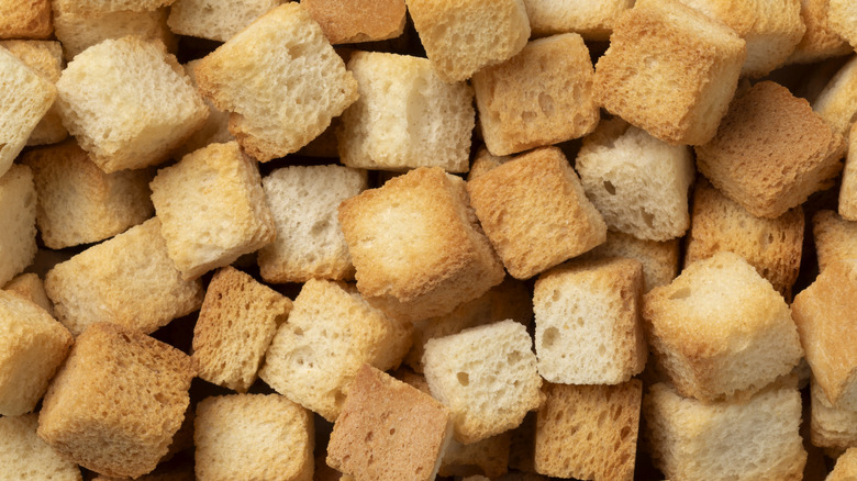 Close up of many freshly baked croutons piled together