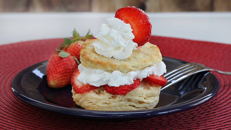 Strawberry shortcake made from a flaky biscuit with strawberries and whipped cream