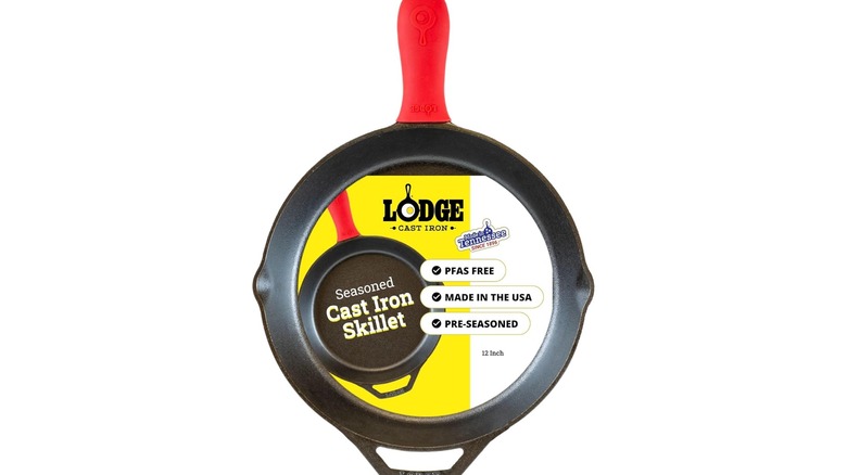A 12 inch Lodge cast iron skillet with red silicone handle