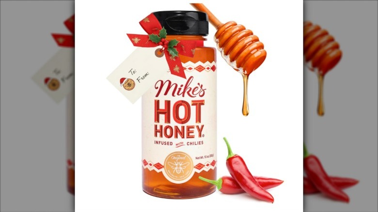 A bottle of Mike's Hot Honey against a white background with a gift tag on it