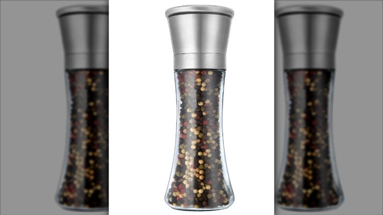 A Mincham Spice Mill filled with peppercorn on a white background