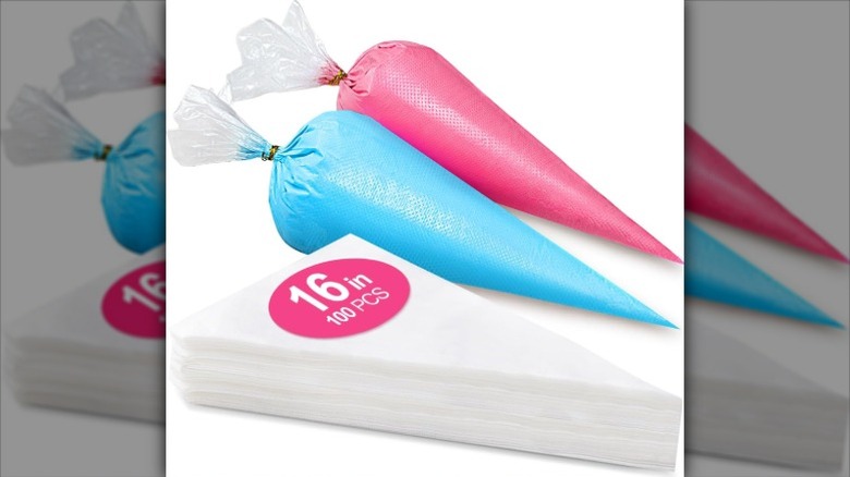 Two filled piping bags in pink and blue next to a stack of 100 Wddeevoi empty piping bags