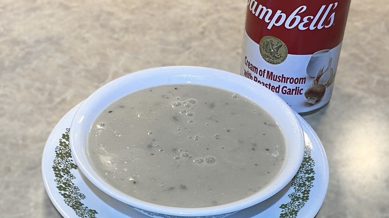 Campbell's Condensed Cream Of Mushroom Soup with Roasted Garlic in bowl next to can