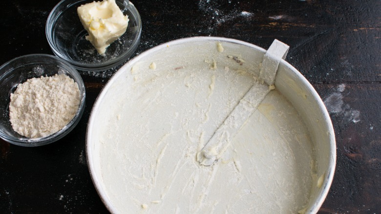 Greased cake tin and bowls