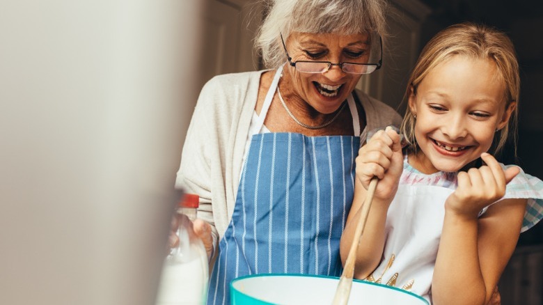 Grandmom and grandaughter making cake