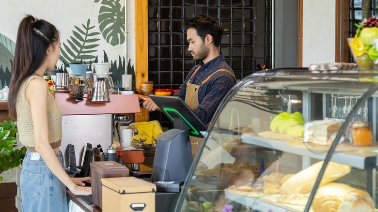 A woman placing an order at a bakery