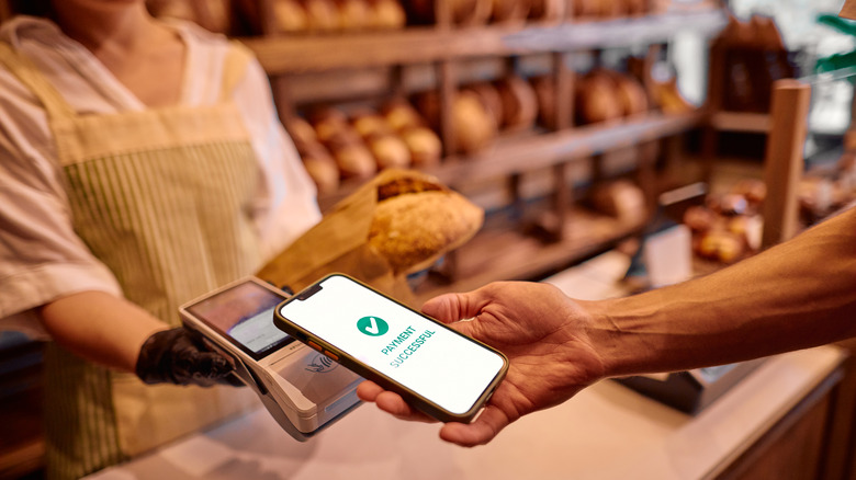 A customer paying for an order at a bakery