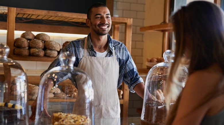 An employee taking a customer's order at a bakery