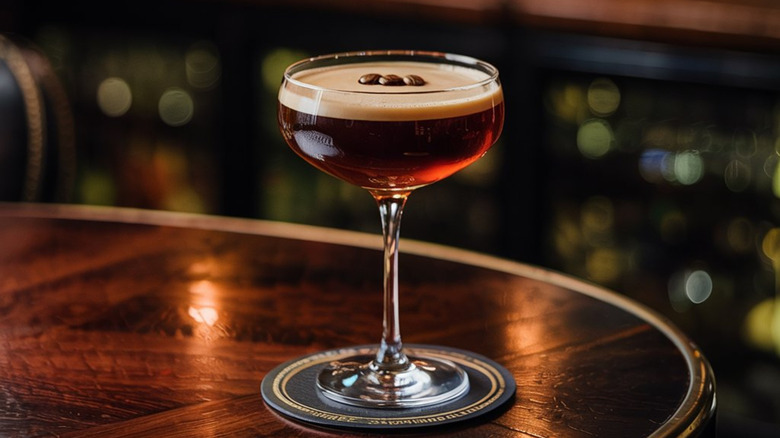 An espresso martini sitting on a wooden table
