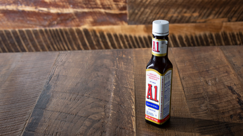 A bottle of A1 steak sauce on a wooden table