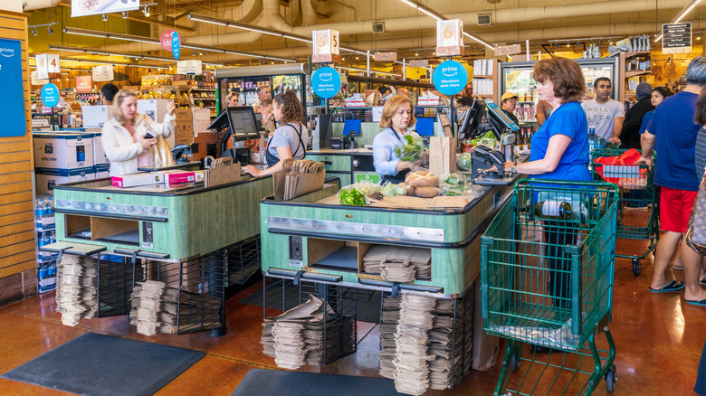 Customers checking out at Whole Foods cashier lines