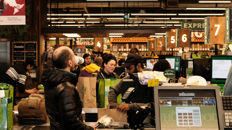 Busy Whole Foods checkout lanes filed with shoppers