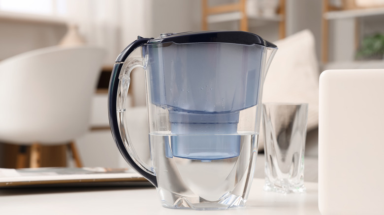 Water in a filter pitcher on a kitchen table