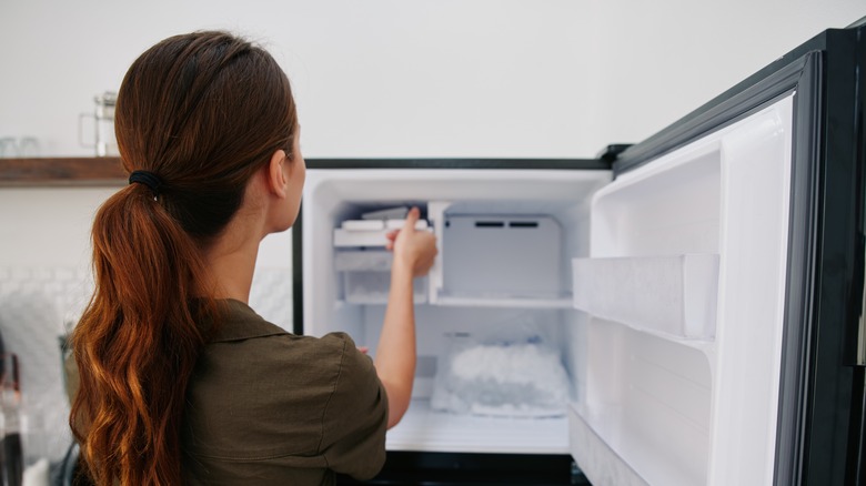 woman emptying freezer