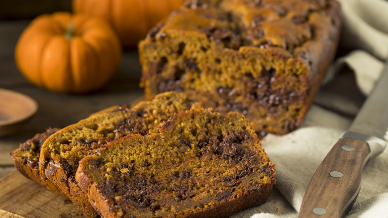 A sliced pumpkin bread loaf with chocolate chips