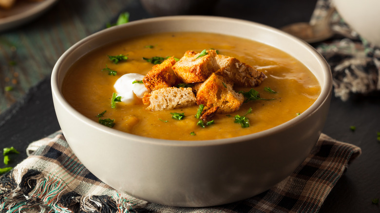 Close-up of a bowl of butternut squash soup topped with croutons