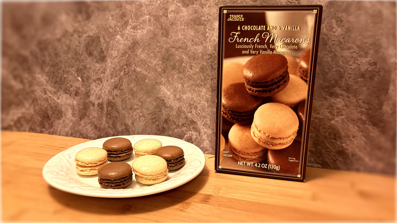 Package and plate of macaron cookies next to the box