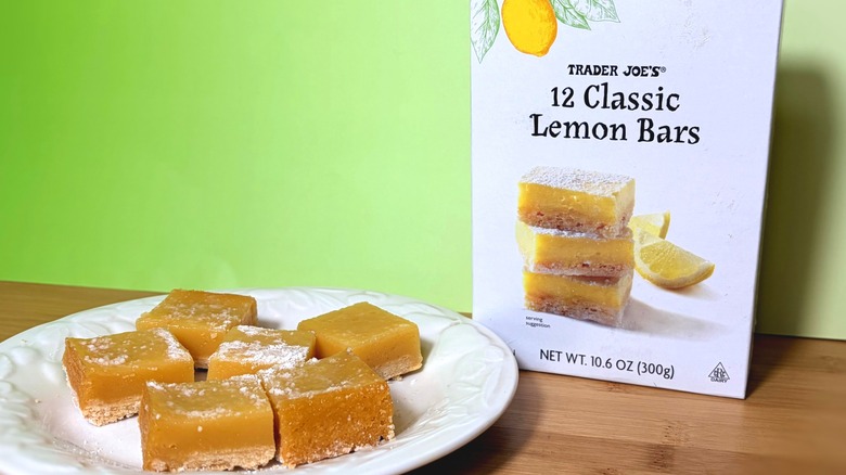 Plate of lemon bar squares in front of the box