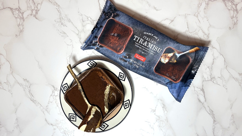 Top view of an Italian tiramisu on a plate, next to its packaging