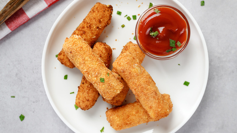 Breaded mozzarella sticks with ketchup