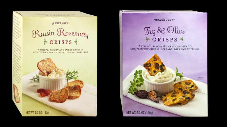 Boxes of Raisin Rosemary and Fig & Olive crisps on a black background