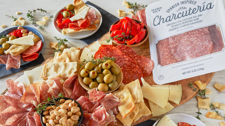 A charcuterie board built with Spanish-style charcuteria, nuts, and olives