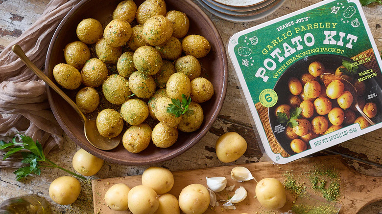 Garlic parsley potato kit in bowl with the package nearby all atop a wooden table.