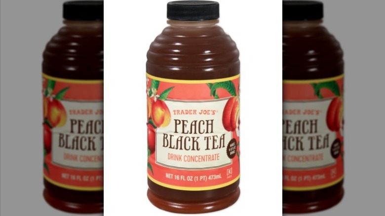 A bottle of peach black tea concentrate on white background