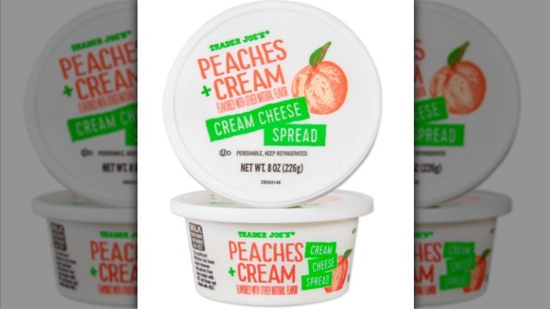 Peaches and cream spread in a white plastic container on white background