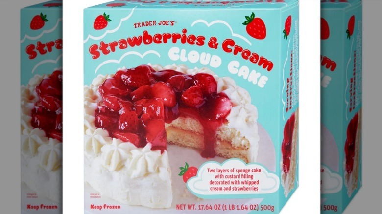 Strawberries and cream cloud cake in a blue box on white background