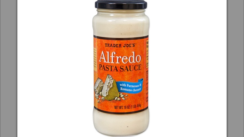 A jar of Trader Joes Alfredo with a white background