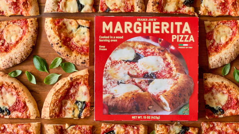 Lots of slices of Margherita pizzas on a wood block next to a package of Trader Joe's pizza