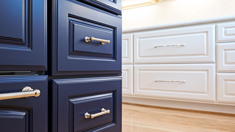 Deep navy-colored cabinets with silver handles