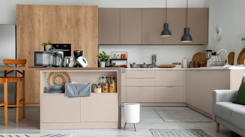 Kitchen with modern clean aesthetic and brown-hued cabinetry