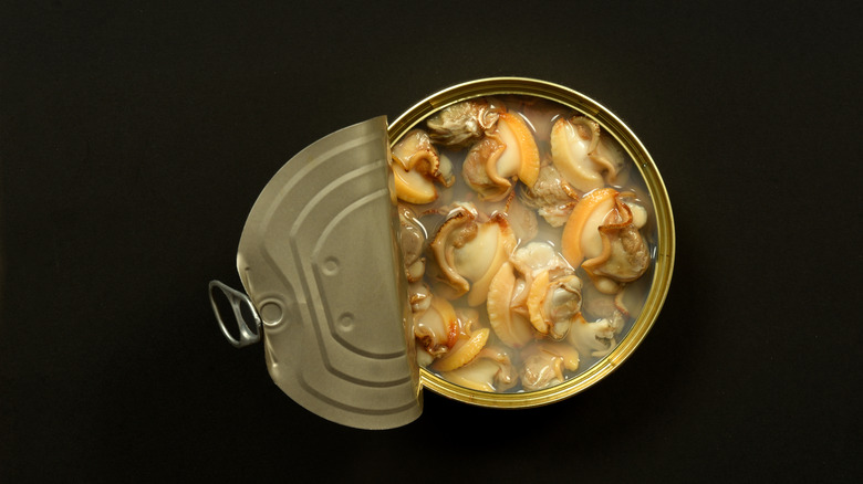 An overhead view of an open can of clams