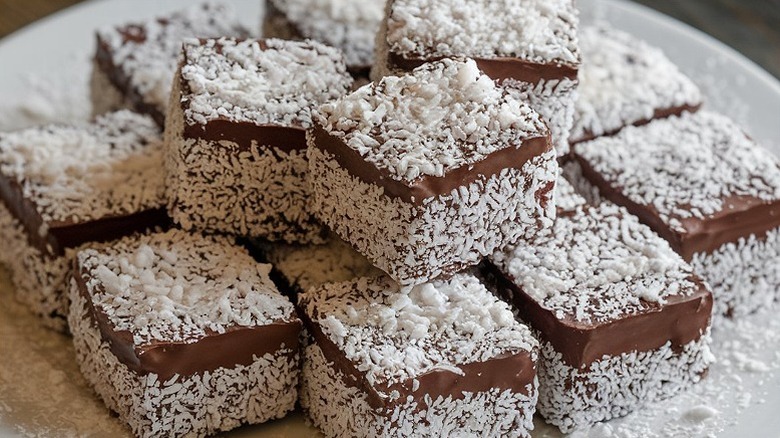 a tray of chocolate lamingtons placed on top of each other